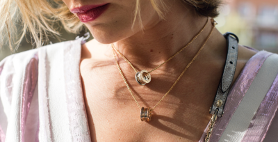 image of a woman wearing two necklaces made from our sustainable material