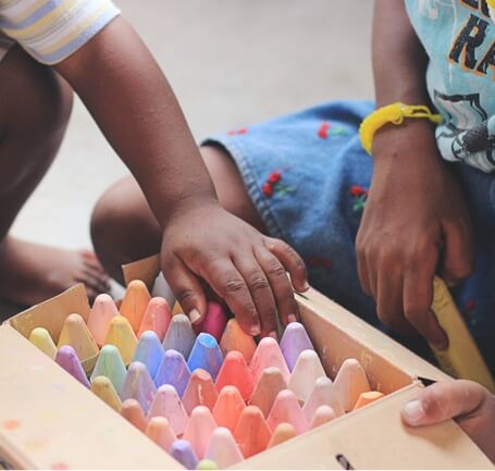 Children playing with crayons.