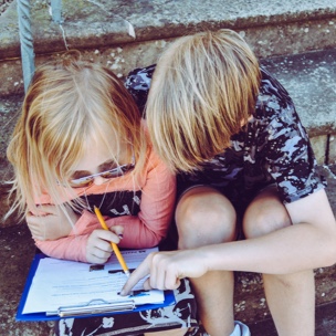 Two children planning events together.